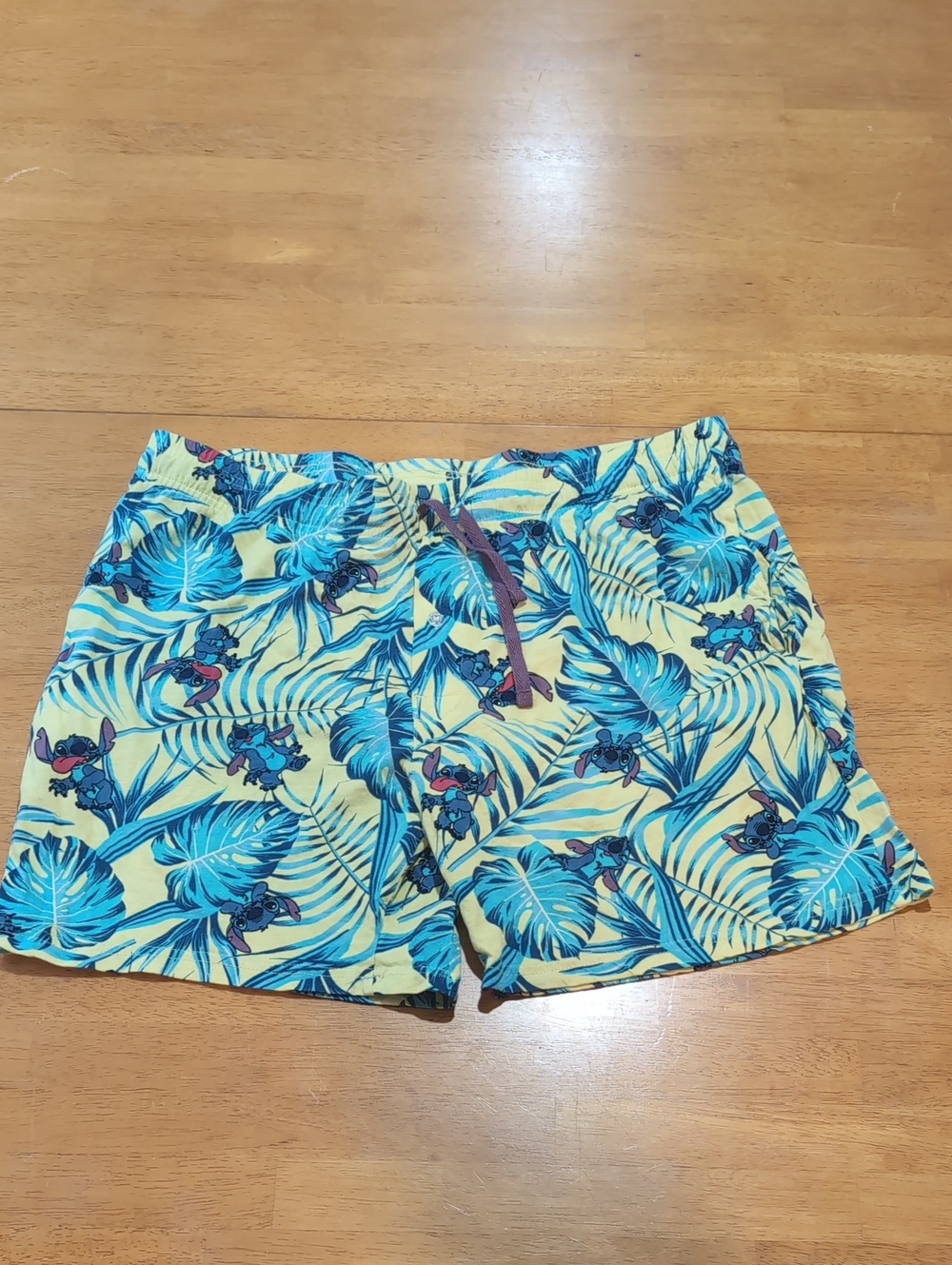 Disney Men's Yellow Stitch Shorts with Blue Tropical Leaf Print